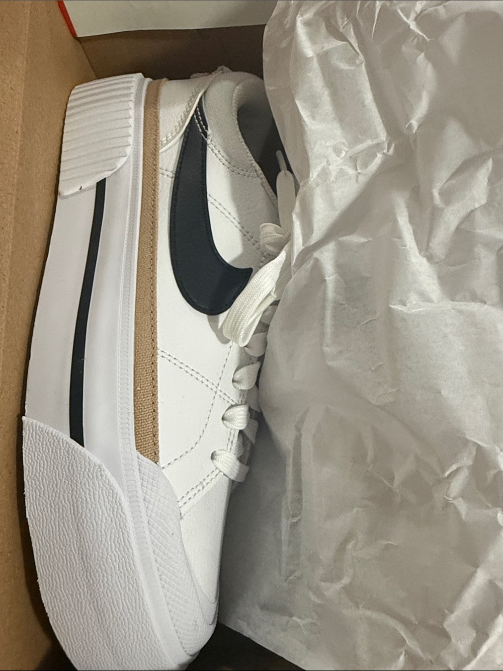Nike Women's White Sneakers with Black Swoosh and Tan Stripe